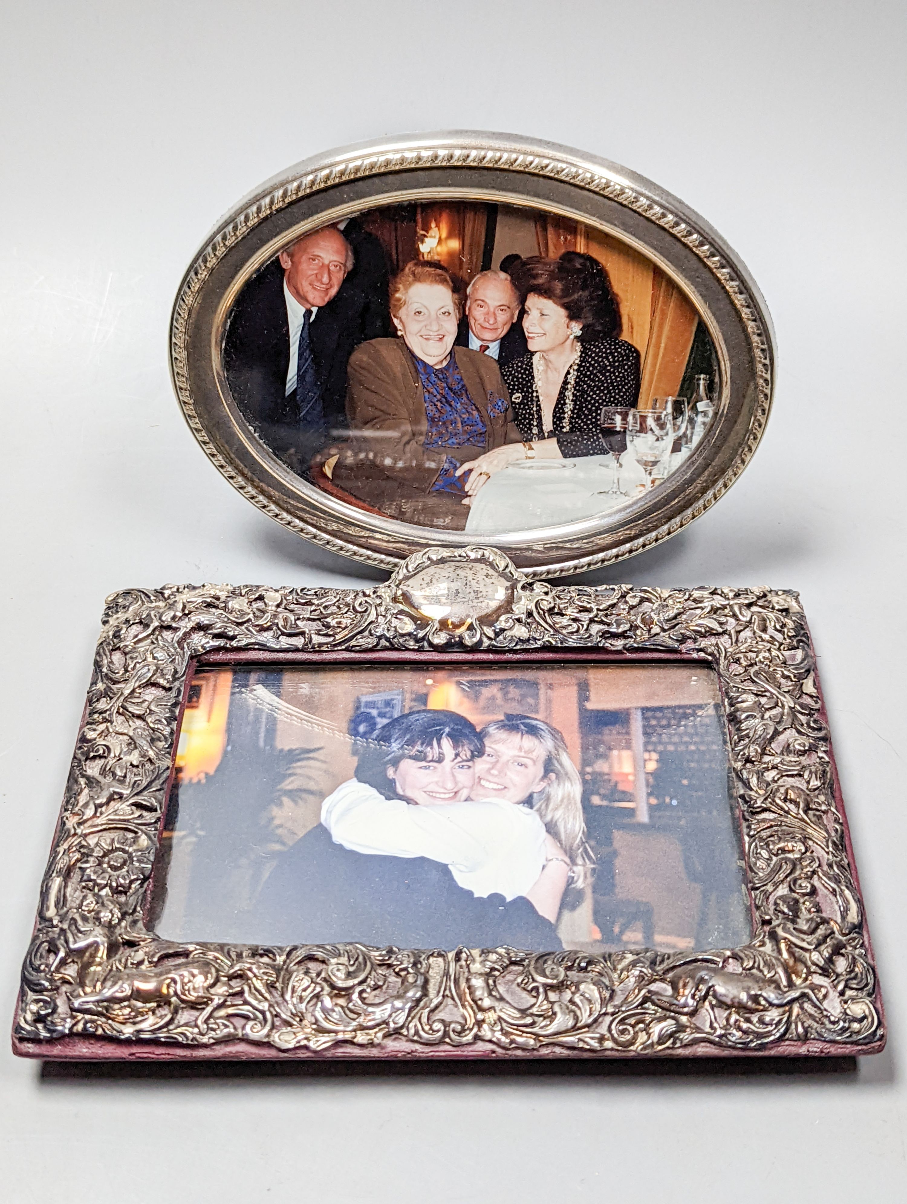 An Edwardian repousse silver mounted photograph frame, Deakin & Francis, Birmingham, 1901, width 19cm and a later modern silver mounted photograph frame.
